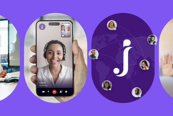 A person holds a smartphone showing a video call with a smiling woman wearing a headset.