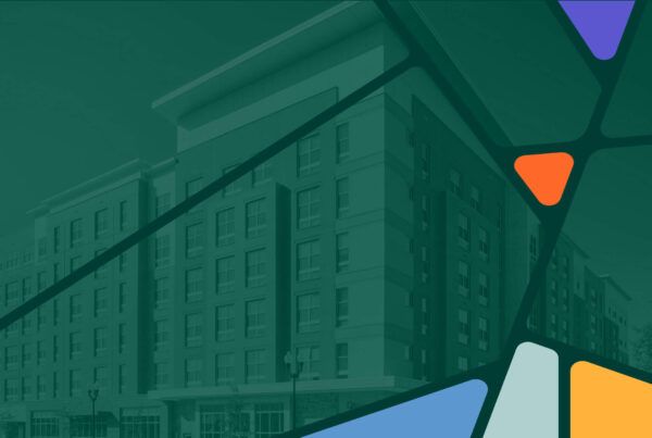 A multi-story building with numerous windows is partially visible behind a colorful, abstract geometric overlay.