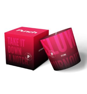 A pink and red candle with the words "Take it down a notch" and "It's fine" on a matching box.