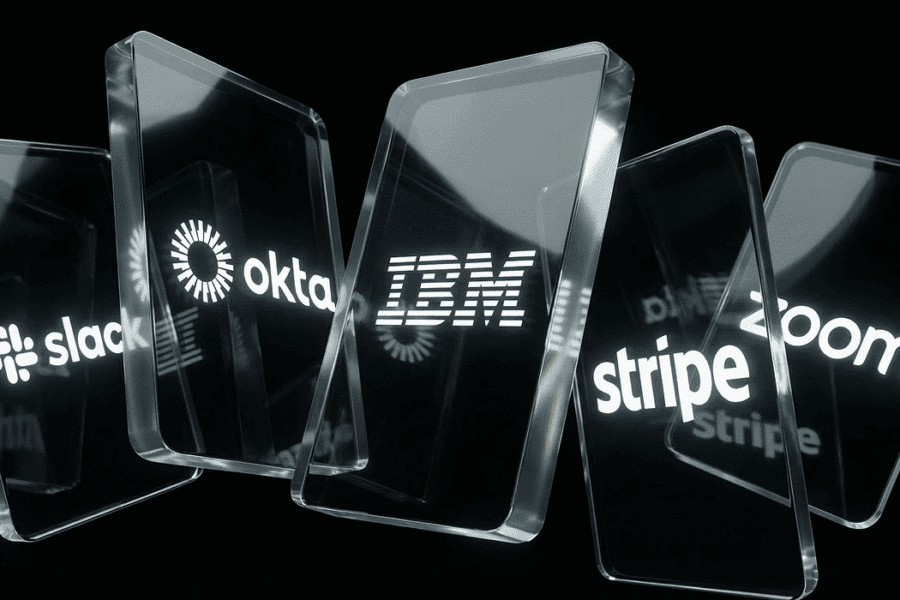 Glass panels displaying the logos of Slack, Okta, IBM, Stripe, and Zoom against a black background.